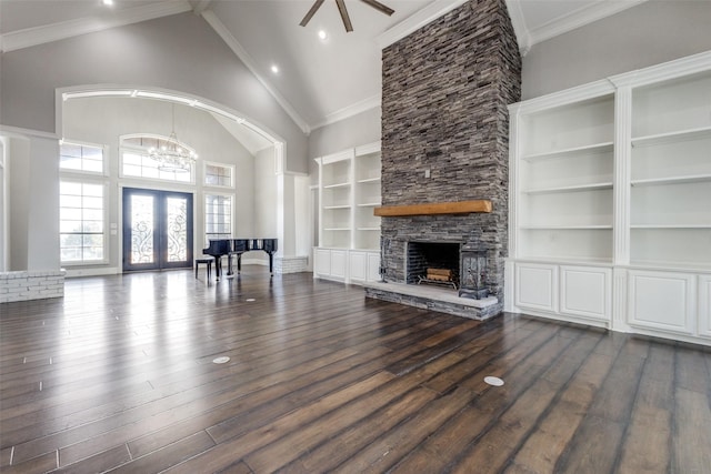 unfurnished living room featuring dark wood-style flooring, crown molding, french doors, a fireplace, and high vaulted ceiling