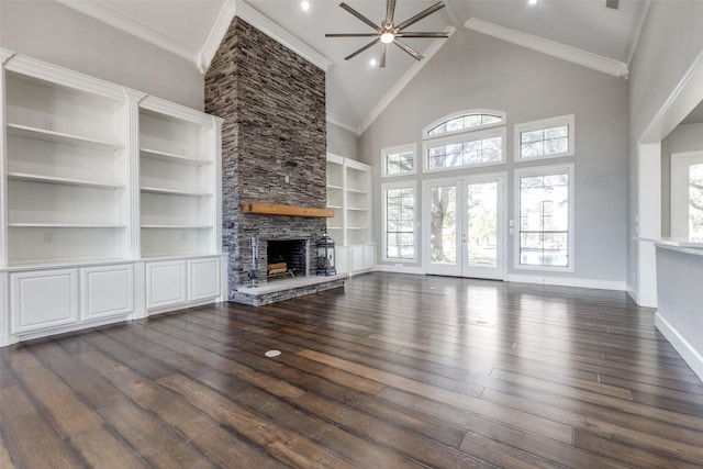 unfurnished living room featuring crown molding, a fireplace, dark wood-style flooring, and french doors