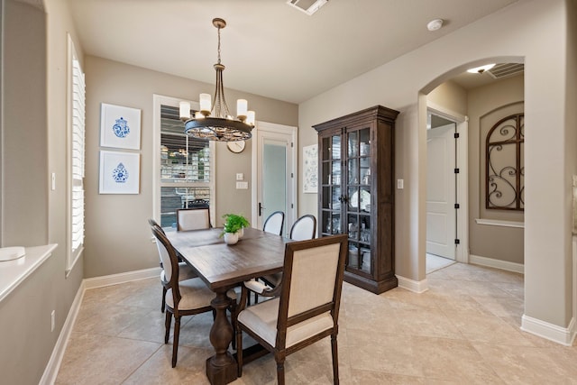 5001 Ellison Ct, Fort Worth, TX 76244 - dining area with arched walkways, visible vents, light tile patterned flooring, a chandelier, and baseboards
