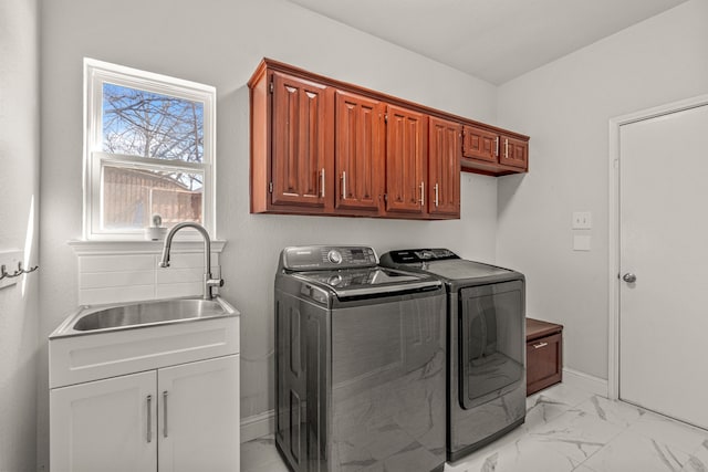 washroom with marble finish floor, cabinet space, a sink, independent washer and dryer, and baseboards