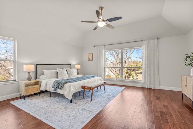 bedroom with lofted ceiling, baseboards, and dark wood finished floors