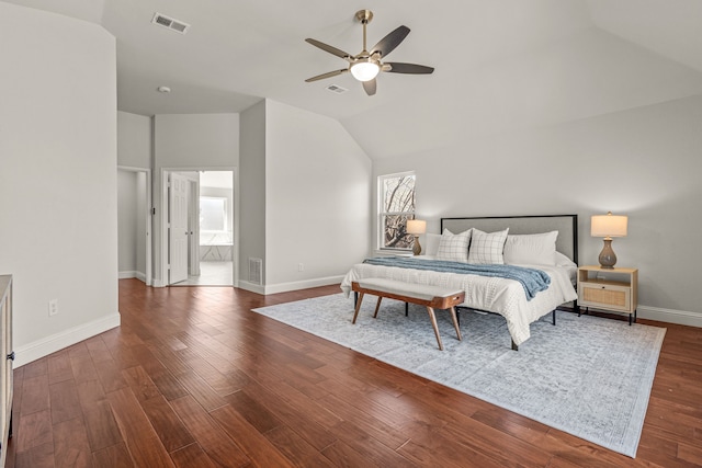 bedroom with lofted ceiling, wood finished floors, visible vents, and baseboards