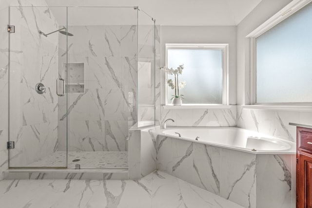 full bath with a garden tub and a marble finish shower