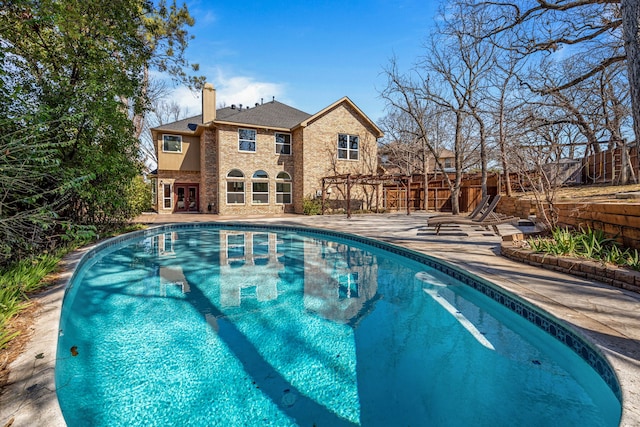 view of pool with fence, french doors, a fenced in pool, a pergola, and a patio area