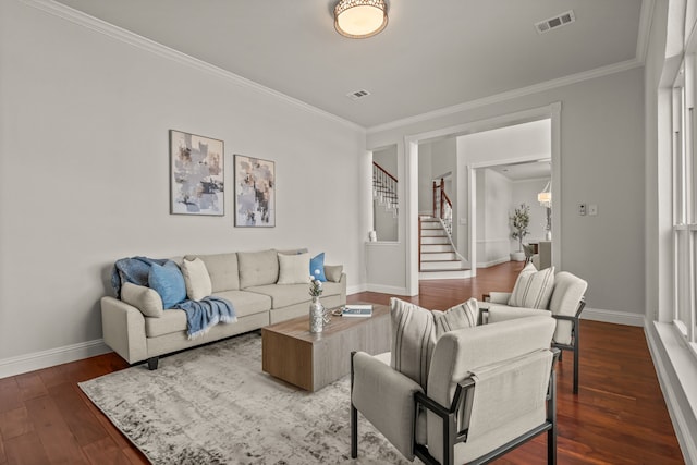 living area with stairway, wood-type flooring, visible vents, and baseboards