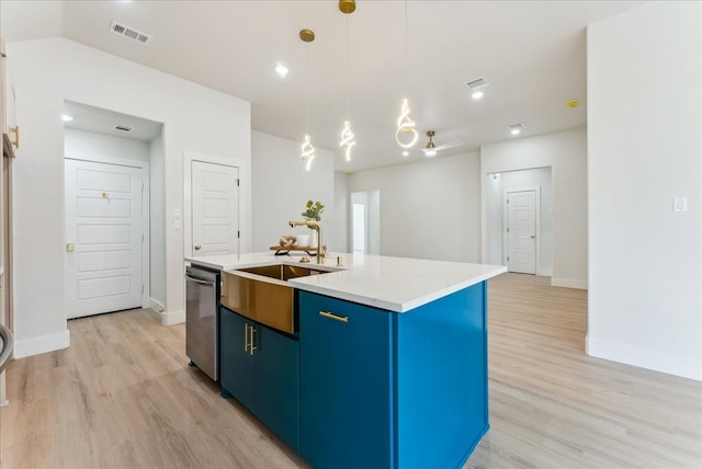 kitchen with a sink, visible vents, light wood-style floors, blue cabinetry, and dishwasher