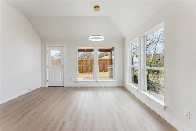 unfurnished sunroom featuring lofted ceiling