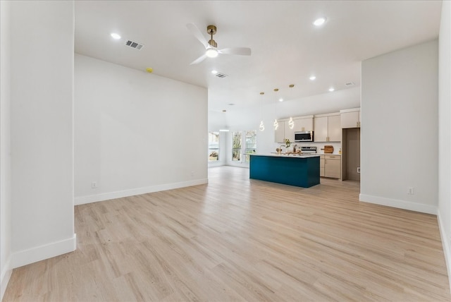 unfurnished living room with light wood-style floors, ceiling fan, visible vents, and baseboards