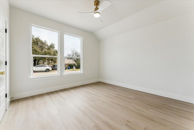 additional living space featuring light wood-type flooring, vaulted ceiling, ceiling fan, and baseboards