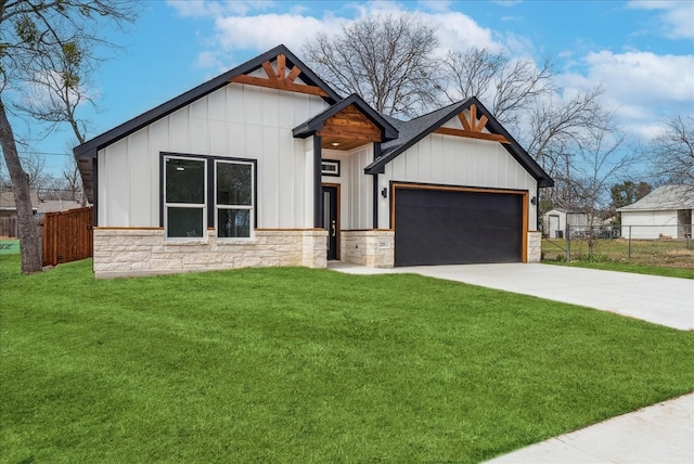 modern farmhouse style home featuring an attached garage, fence, driveway, stone siding, and board and batten siding