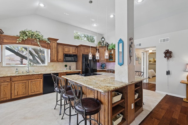 kitchen featuring brown cabinetry, visible vents, open shelves, a sink, and black appliances