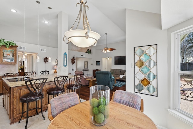 dining area with a wealth of natural light, visible vents, and ceiling fan