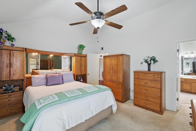 bedroom featuring ceiling fan, connected bathroom, light colored carpet, and high vaulted ceiling