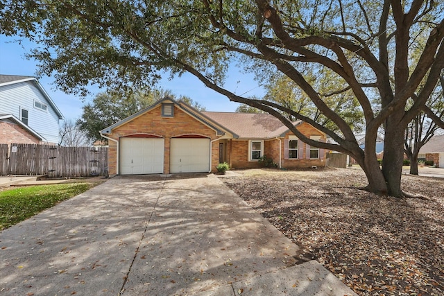 ranch-style home with brick siding, driveway, an attached garage, and fence