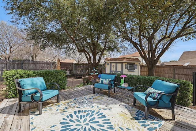 wooden deck with an outbuilding and a fenced backyard