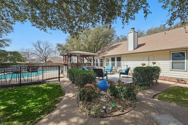 exterior space with a fenced in pool, fence, a chimney, outdoor lounge area, and a patio area