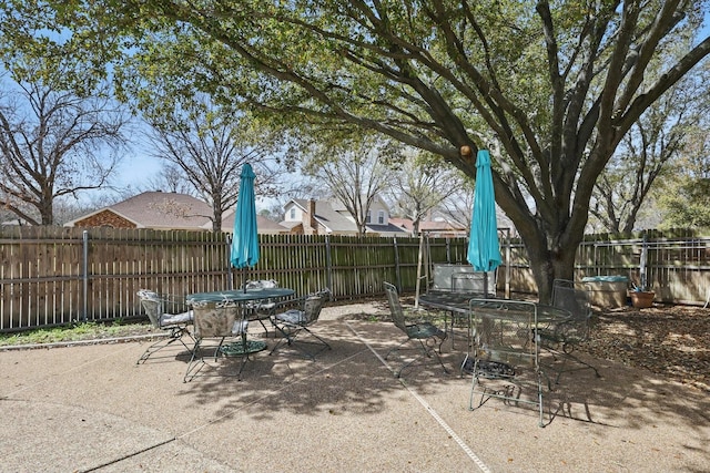 view of patio featuring outdoor dining area and a fenced backyard