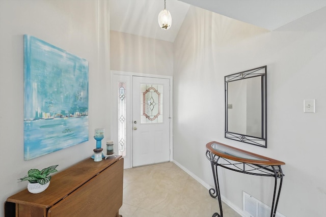 entryway with vaulted ceiling and baseboards