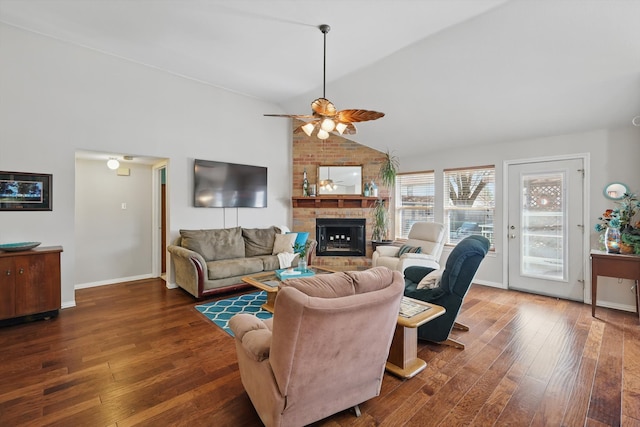 living room with lofted ceiling, a brick fireplace, ceiling fan, and hardwood / wood-style flooring