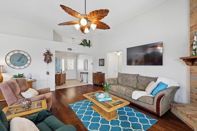 living area featuring a ceiling fan, visible vents, wood-type flooring, and high vaulted ceiling