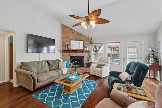 living room with dark wood-style floors, a fireplace, baseboards, ceiling fan, and vaulted ceiling