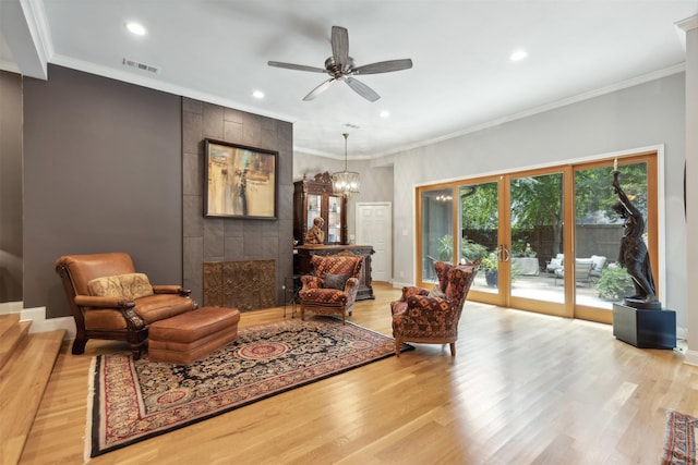 living room featuring recessed lighting, visible vents, french doors, light wood-type flooring, and crown molding