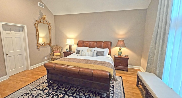 bedroom featuring visible vents, baseboards, and wood finished floors