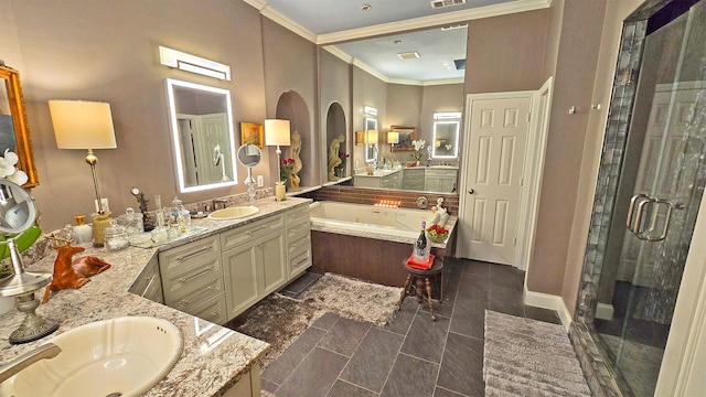 bathroom featuring ornamental molding, a stall shower, a sink, and visible vents