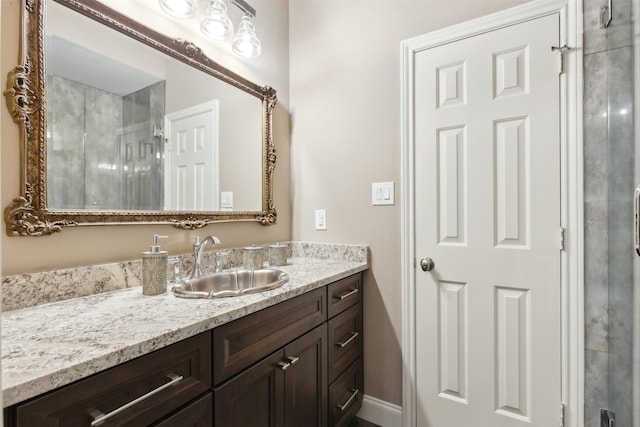 bathroom featuring an enclosed shower and vanity