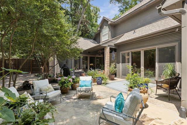 view of patio featuring an outdoor hangout area and fence