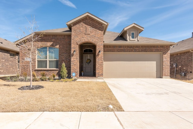 french country inspired facade featuring a garage, concrete driveway, brick siding, and roof with shingles