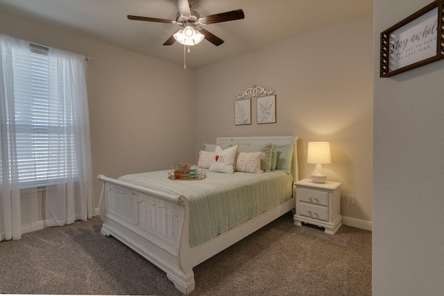 bedroom with a ceiling fan, carpet flooring, and baseboards