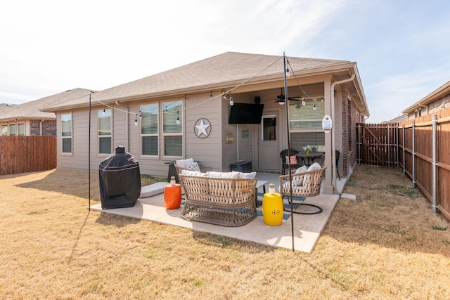 back of house with a patio area, a fenced backyard, a ceiling fan, and a yard