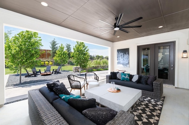 view of patio with an outdoor living space with a fire pit, a ceiling fan, and fence