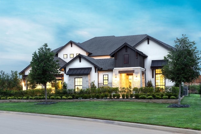 modern farmhouse style home featuring a shingled roof, a standing seam roof, metal roof, and a front lawn