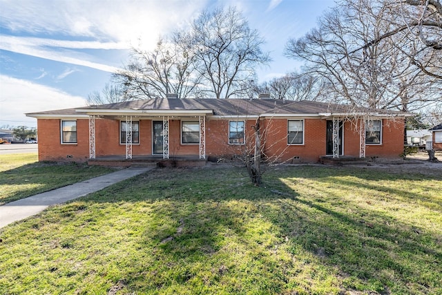 ranch-style house with covered porch, brick siding, crawl space, a front lawn, and a chimney