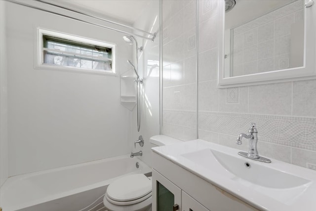 bathroom featuring toilet, vanity, tile walls, shower / bathing tub combination, and backsplash