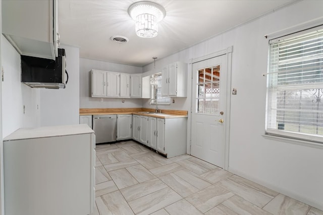 kitchen with light countertops, white cabinetry, a sink, dishwasher, and white refrigerator