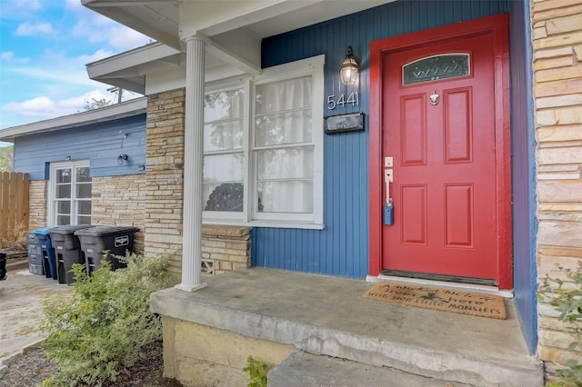 doorway to property with stone siding