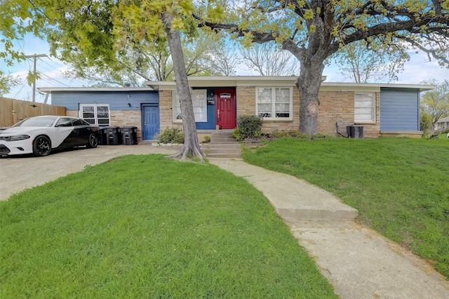 single story home featuring a front yard, stone siding, and central AC