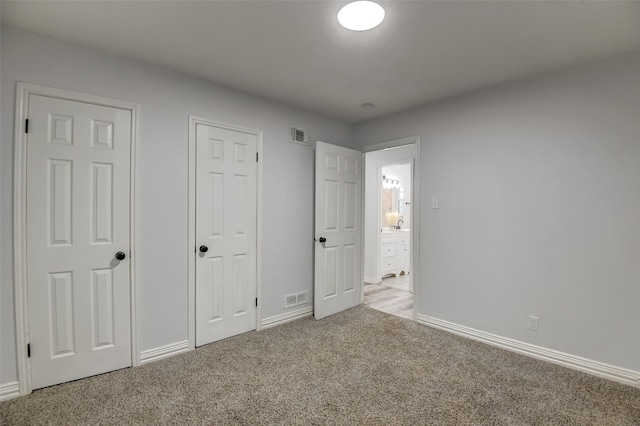 unfurnished bedroom with light carpet, baseboards, and visible vents