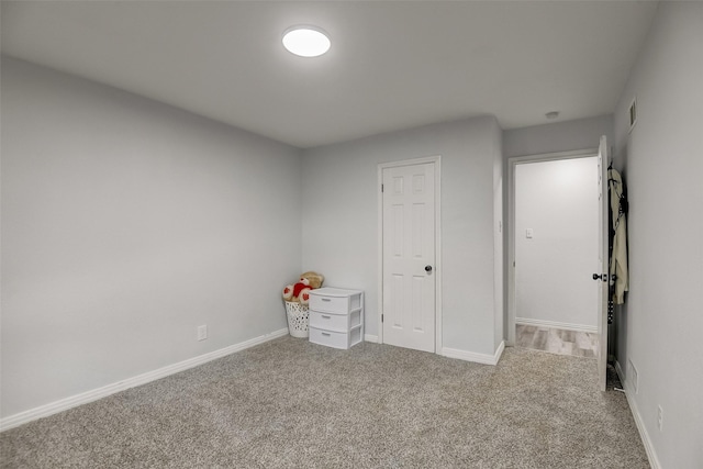 unfurnished bedroom with carpet and baseboards