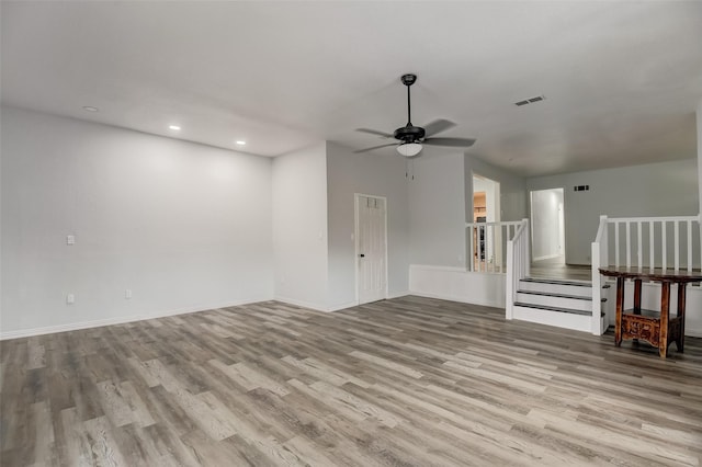 unfurnished living room featuring baseboards, visible vents, a ceiling fan, wood finished floors, and recessed lighting