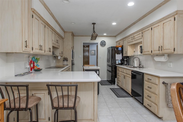 kitchen featuring light tile patterned floors, light countertops, light brown cabinetry, black appliances, and a sink