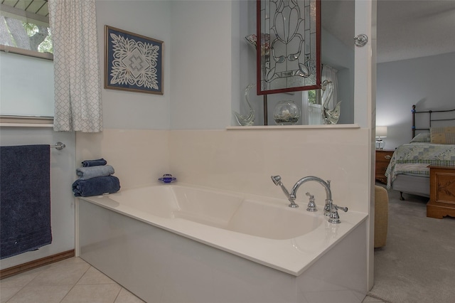 ensuite bathroom featuring ensuite bathroom, tile patterned flooring, and a bath