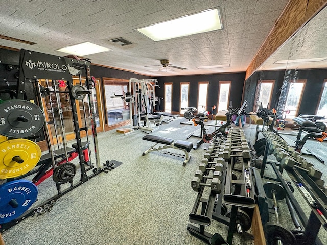 gym featuring visible vents and a ceiling fan