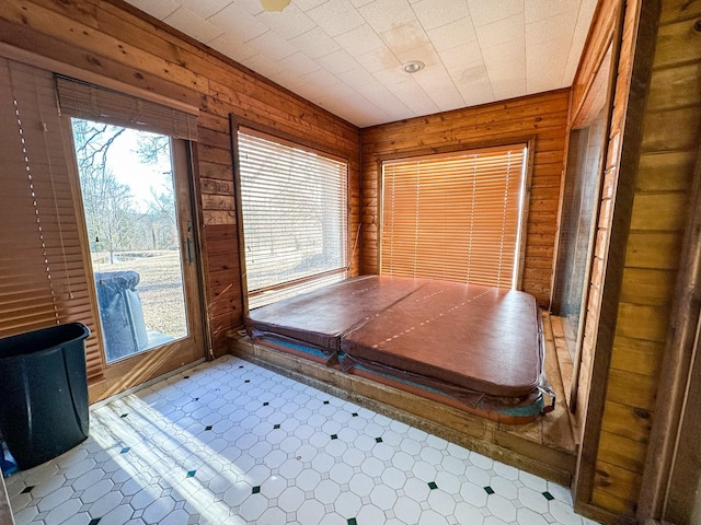 interior space featuring wood walls and tile patterned floors