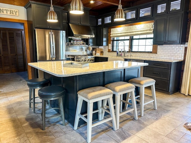 2626 County Road 2621, Marietta, TX 75566 - kitchen featuring backsplash, freestanding refrigerator, extractor fan, and light stone counters