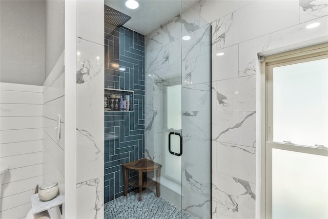 bathroom with a marble finish shower