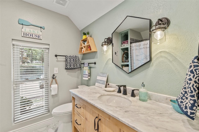 bathroom featuring visible vents, toilet, marble finish floor, vaulted ceiling, and vanity